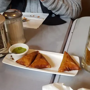 a plate of food and a glass of beer