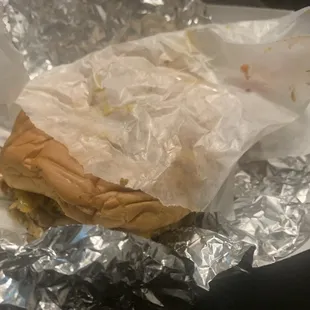 a sandwich wrapped in aluminum foil