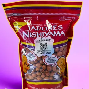 a bag of peanuts on a pink background