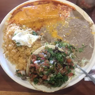 Cheese enchilada and carne asada taco combination (stole sour cream from my fiancé&apos;s plate)