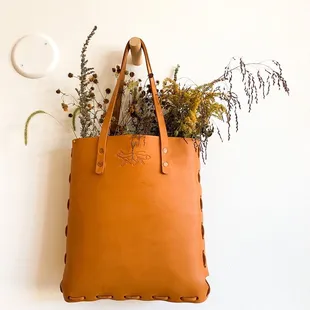 a plant in a leather bag