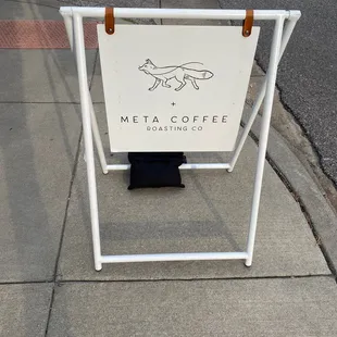 a sign on the sidewalk