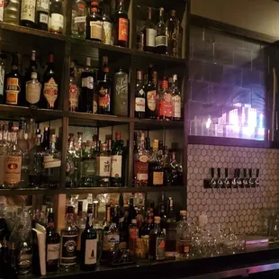 a bar with many bottles of alcohol