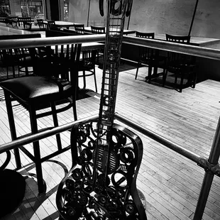 a black and white photo of a guitar