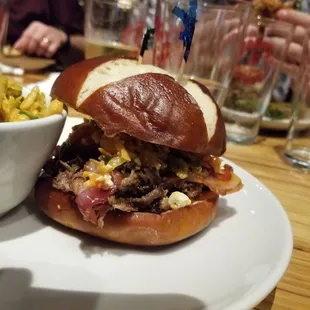 Brewer BBQ pulled beef sandwich on a pretzel roll.