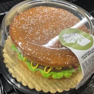 a hamburger in a plastic container