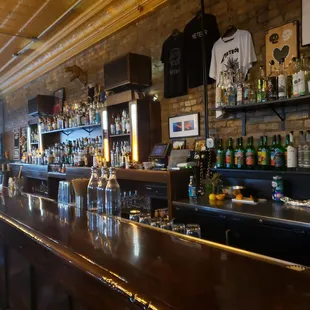 a bar with bottles of alcohol on the counter