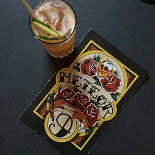 a drink and a card on a table
