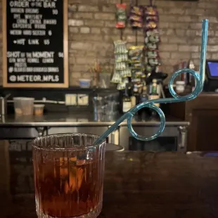 a drink in a glass on a bar