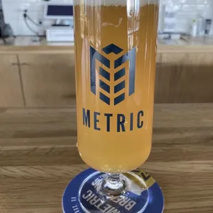 a glass of beer on a coaster