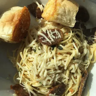 Italian sausage pasta bistro with garlic bread on the side