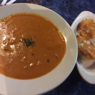 Bowl of Tomato Bisque Soup and a couple slices toasted bread...