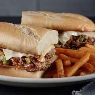 two sandwiches and french fries on a plate