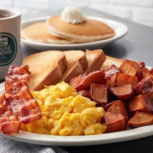 a breakfast of eggs, bacon and pancakes