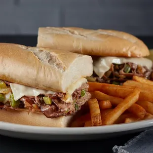 two sandwiches and french fries on a plate