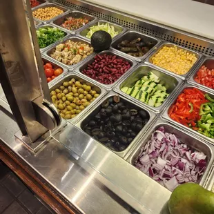 a salad bar with a variety of vegetables