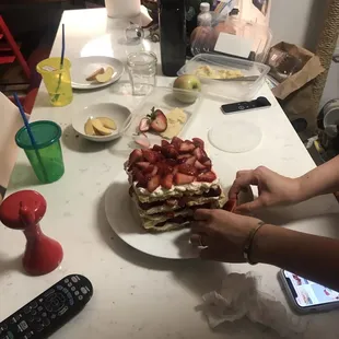 a person cutting a cake