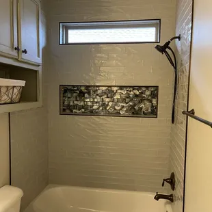 a bathroom with a tub, toilet, and sink