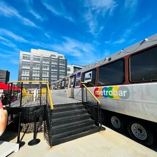 a man taking a picture of a metro bus