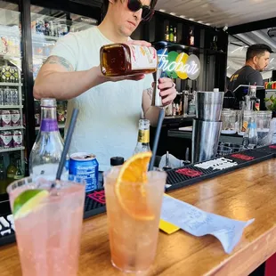 a bartender pouring a drink