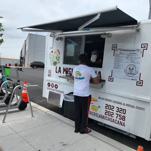 a man ordering food from a food truck