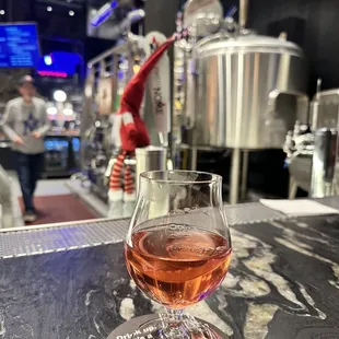 a glass of wine on a bar