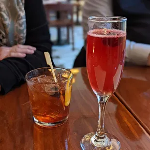 a glass of wine and a drink on a table