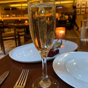 a glass of champagne on a table
