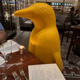 They put one of the many yellow penguins at our table after my son hugged it