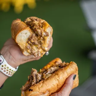 a hand holding a sandwich