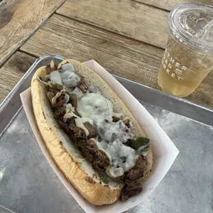 Philly Cheesesteak with mozzarella, peppers, and onions.