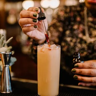 a woman pouring a drink