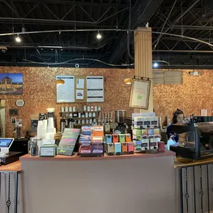 a coffee shop counter with a variety of coffees