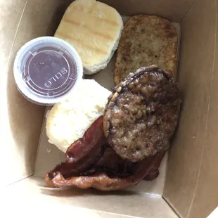 Make your own breakfast plate-- biscuits with jam, hash brown, bacon, and sausage.