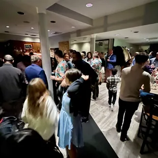 Upon entrance. Bar in front in left side. Right side takes you to food and bigger room area.