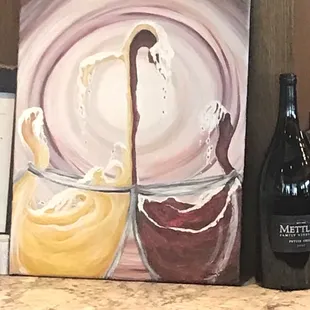 a bottle of wine and a painting