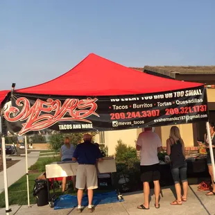 people standing under a tent