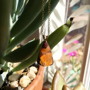 Fire opal found in Las Cruces. Hand shaped and mounted with gold filled setting and chain