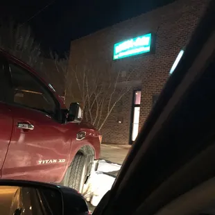 a red truck parked in front of a business