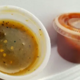 a bowl of soup and a container of sauce