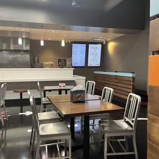 a dining area with tables and chairs