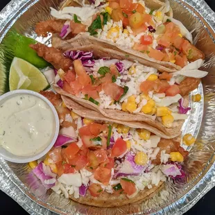 Beer Battered Fish Tacos (3). Corn tortillas, white fish, purple &amp; green cabbage, corn, queso fresco, pico, creamy avocado sauce. $11.50.