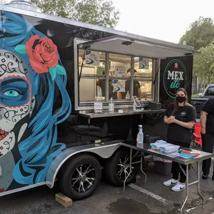 "Storefront" shot outside the food truck. Ordering table and window.