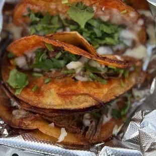Birria queso tacos with cilantro and onions