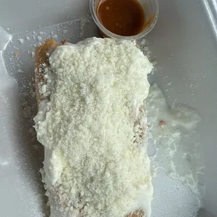 Pork Tamale with cheese and sour cream and hot sauce / Tamale de puerco con queso y crema y salsa roja yummmm!