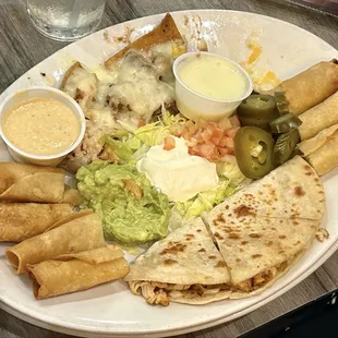 This is like a sampler plate. Quesadillas and flautas and nachos with guacamole and cheese dip. Blanco queso.