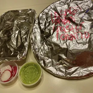 7 super tacos packed to go on styrofoam tray and plate covered w foil
