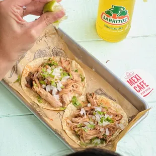 a person taking a bite out of a taco