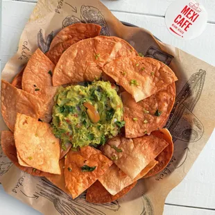 a plate of nachos with guacamole