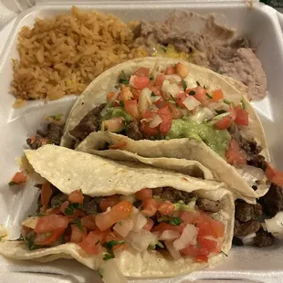 Carne Asada Taco x 2 with guacamole, pico, and a hefty serving of carne asada, rice, and beans. So yummy!